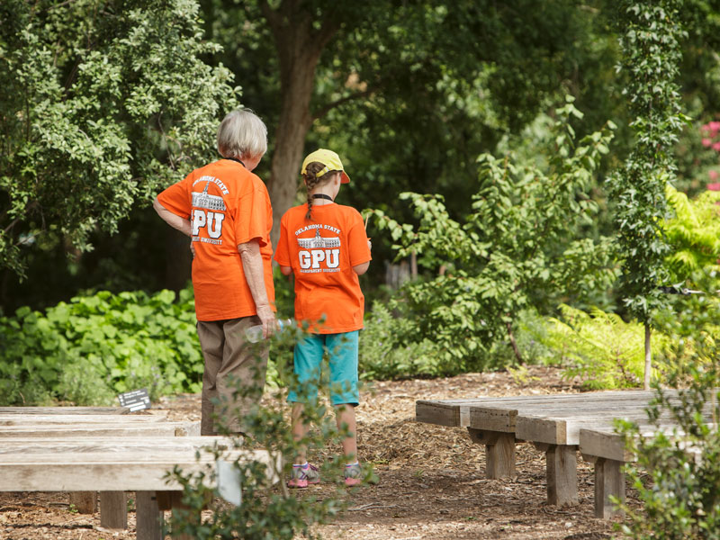 Grandparent and student exploring the botanic gardens together